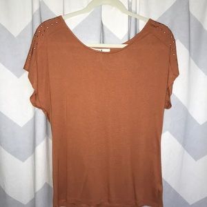 burnt orange top with studs on sleeves